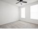 Bright bedroom with neutral carpet, ceiling fan, and natural light from two windows at 7188 Covington St, Lebanon, IN 46052