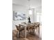 Inviting dining room features wood table with modern chandelier and artwork on the wall at 7188 Covington St, Lebanon, IN 46052
