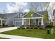 A beautiful single-story home with an attached garage, small porch area, and vibrant green lawn at 7188 Covington St, Lebanon, IN 46052
