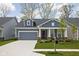 Charming single-story home features a well-manicured lawn, attached garage, and inviting front porch at 7188 Covington St, Lebanon, IN 46052