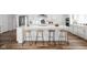 Beautiful kitchen island with seating, quartz countertops, and modern fixtures offering ample space at 7188 Covington St, Lebanon, IN 46052