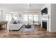 Comfortable living room with a plush sofa, fireplace, and large windows, perfect for relaxation at 7188 Covington St, Lebanon, IN 46052