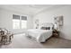 Bright main bedroom with tray ceiling features neutral decor, carpet, and two decorative lamps at 7188 Covington St, Lebanon, IN 46052