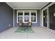 Covered patio with seating area includes two chairs, an area rug, and sliding glass doors at 7188 Covington St, Lebanon, IN 46052
