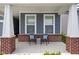 Charming front porch featuring seating, brick accents, and an inviting entryway at 7188 Covington St, Lebanon, IN 46052