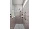 Modern shower with wood-look tile, glass enclosure, handheld sprayer, and built-in shelves at 7188 Covington St, Lebanon, IN 46052
