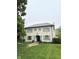 Charming two-story home featuring a light brick exterior, gray shutters, and a well-manicured lawn at 7525 N Pennsylvania St, Indianapolis, IN 46240