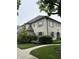 Two-story house with light brick and gray shutters, complemented by lush landscaping and a sidewalk at 7525 N Pennsylvania St, Indianapolis, IN 46240