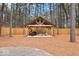 Spacious backyard featuring a custom wooden pavilion with ample seating, perfect for outdoor entertaining at 7643 Dean Rd, Indianapolis, IN 46240