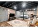 Finished basement featuring a basketball hoop, exposed brick, and sleek black ceiling at 7643 Dean Rd, Indianapolis, IN 46240