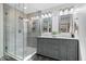 Modern bathroom featuring a glass-enclosed shower and double vanity with stylish fixtures and lighting at 7643 Dean Rd, Indianapolis, IN 46240