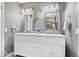 Bathroom featuring a dual vanity with decorative mirrors and modern lighting at 7643 Dean Rd, Indianapolis, IN 46240