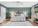 Stylishly designed bedroom with green accent wall, soft rug, and vanity area near the window at 7643 Dean Rd, Indianapolis, IN 46240