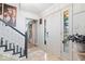 Welcoming foyer with tiled floor, white trim, and a view of the staircase at 7643 Dean Rd, Indianapolis, IN 46240