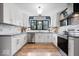 Modern kitchen features white cabinetry, granite countertops, and stainless steel appliances at 7643 Dean Rd, Indianapolis, IN 46240