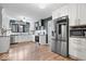 Modern kitchen features white cabinetry, granite countertops, and stainless steel appliances at 7643 Dean Rd, Indianapolis, IN 46240