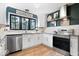 Modern kitchen features white cabinetry, granite countertops, and stainless steel appliances at 7643 Dean Rd, Indianapolis, IN 46240