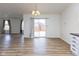 Bright dining space with a view of the backyard, wood floors, and open access to the living area at 8091 Crumwell Dr, Avon, IN 46123