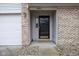 A covered entryway with a brick facade and a decorative front door enhances curb appeal at 8091 Crumwell Dr, Avon, IN 46123
