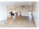 Spacious open-concept living area showcasing wood flooring, ample natural light, and a modern kitchen at 8091 Crumwell Dr, Avon, IN 46123
