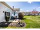 Landscaped backyard with patio, outdoor seating, grill, white privacy fence, and lush green lawn at 10246 Eller Creek Dr, Fishers, IN 46038