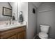 Well-lit half bath with a wooden vanity, white countertop, and modern fixtures at 10246 Eller Creek Dr, Fishers, IN 46038