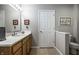 Bathroom with a light wood vanity, white countertop, faucet, large mirror, and neutral wall color at 10246 Eller Creek Dr, Fishers, IN 46038