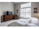 Bedroom with a dresser, large window, neutral carpet, and a queen-size bed at 10246 Eller Creek Dr, Fishers, IN 46038