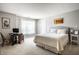 Bright bedroom featuring carpet, neutral walls, a comfortable queen-sized bed, and a functional workspace at 10246 Eller Creek Dr, Fishers, IN 46038