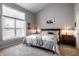 Bedroom with large window, neutral carpet, and a queen-size bed with matching furniture at 10246 Eller Creek Dr, Fishers, IN 46038
