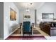 Stylish dining room with a modern chandelier and open access to the kitchen at 10246 Eller Creek Dr, Fishers, IN 46038