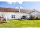 Back exterior view of a home with a patio, grill, green lawn, and white siding at 10246 Eller Creek Dr, Fishers, IN 46038