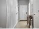 Clean, bright hallway with multiple doors, neutral paint, and a decorative side table at 10246 Eller Creek Dr, Fishers, IN 46038