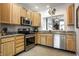 Well-lit kitchen featuring stainless steel appliances, granite counters, and ample cabinet space at 10246 Eller Creek Dr, Fishers, IN 46038
