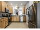 Modern kitchen with stainless steel appliances, light wood cabinets, and granite countertops at 10246 Eller Creek Dr, Fishers, IN 46038