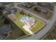 An aerial view of a two-story home that features an in-ground pool and a basketball court at 1032 Westview Point Dr, Columbus, IN 47201
