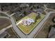An aerial view showcasing a well-defined property line, mature trees, a swimming pool, and surrounding homes at 1032 Westview Point Dr, Columbus, IN 47201