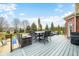 Expansive back deck with gray composite flooring features a large dining table and seating area, perfect for entertaining at 1032 Westview Point Dr, Columbus, IN 47201