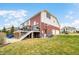 A spacious backyard, featuring a two-story home with a brick exterior and a deck at 1032 Westview Point Dr, Columbus, IN 47201