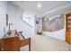 Basement featuring staircase, carpeted floors, artwork, and a piano at 1032 Westview Point Dr, Columbus, IN 47201