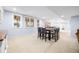 Basement dining area with natural light, large dining table, and nearby bar at 1032 Westview Point Dr, Columbus, IN 47201
