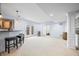 Finished basement with carpeted floors, wet bar, counter seating, and walkout to the backyard at 1032 Westview Point Dr, Columbus, IN 47201