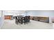 Spacious basement dining area with a large table, seating, and adjacent wet bar area at 1032 Westview Point Dr, Columbus, IN 47201
