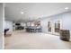 Large finished basement area with a wet bar, seating, and walkout to the backyard at 1032 Westview Point Dr, Columbus, IN 47201