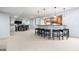Basement wet bar with pendant lights, counter seating, and nearby dining area at 1032 Westview Point Dr, Columbus, IN 47201