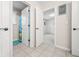 Bright bathroom with tiled floor, neutral walls, and white cabinetry at 1032 Westview Point Dr, Columbus, IN 47201