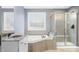 Bright bathroom featuring a soaking tub, glass shower, and vanity with sink at 1032 Westview Point Dr, Columbus, IN 47201