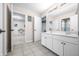 Bright bathroom featuring double vanity, tiled floor, white cabinetry, and neutral walls at 1032 Westview Point Dr, Columbus, IN 47201