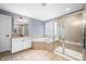 Bathroom with a soaking tub, tiled floors, and a glass-enclosed shower at 1032 Westview Point Dr, Columbus, IN 47201