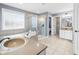 Bright bathroom featuring a soaking tub, glass shower, and dual sinks at 1032 Westview Point Dr, Columbus, IN 47201
